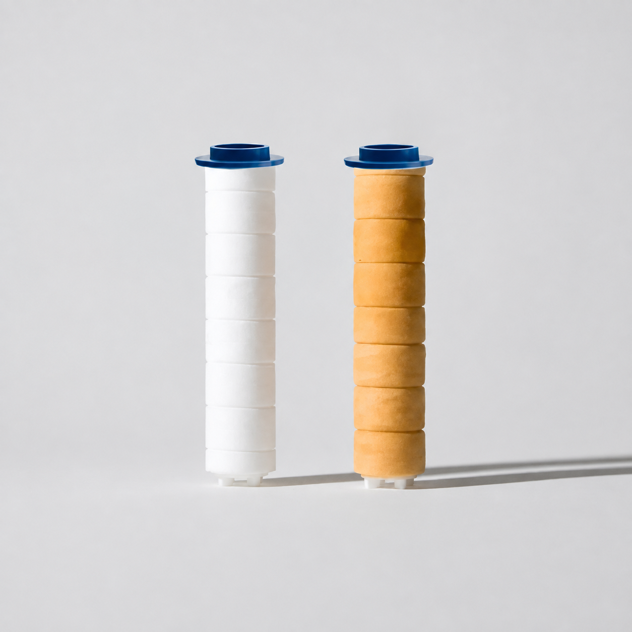 A new white RAINLY filter cartridge beside one discolored after 60 days of use